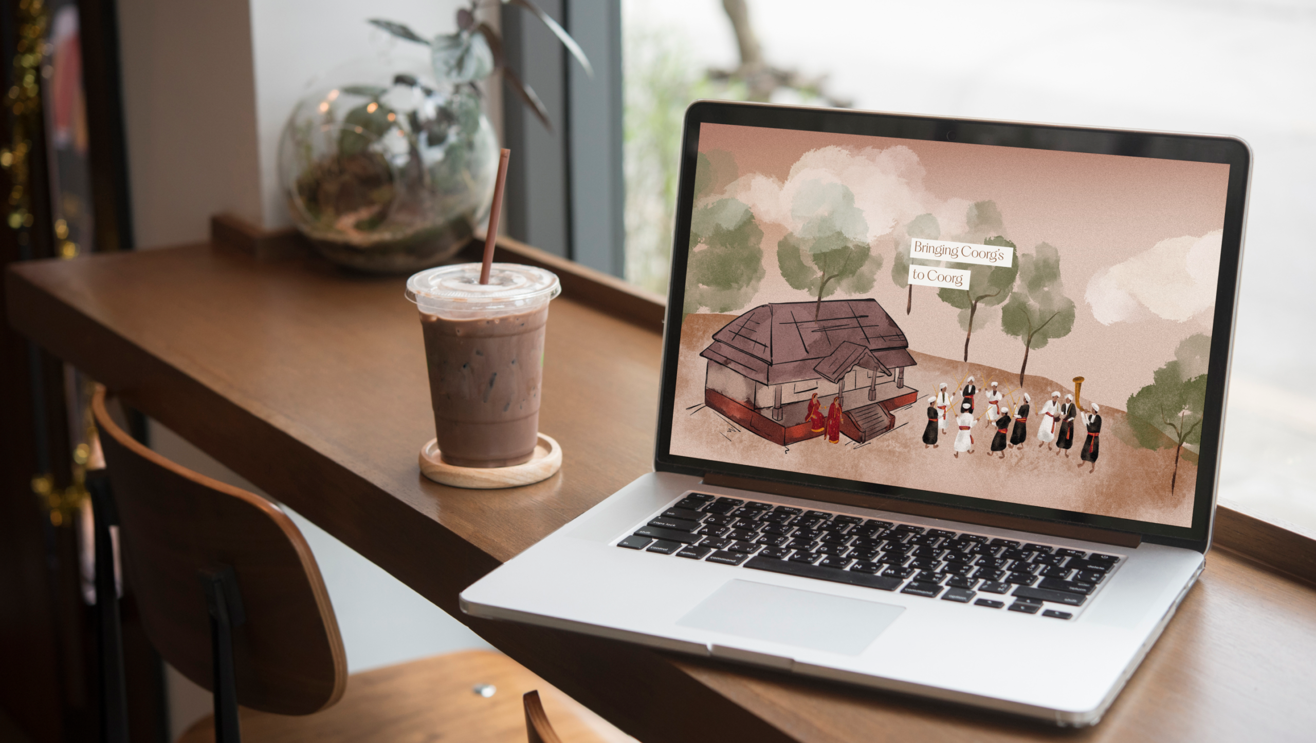 The image of blossom heights laptop mockup with illustration of coorg's life designed by Wings